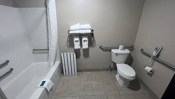 A bathroom with a bathtub, toilet, and shower.