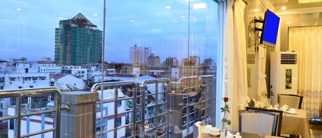 A restaurant with a view of a cityscape, including a building under construction.