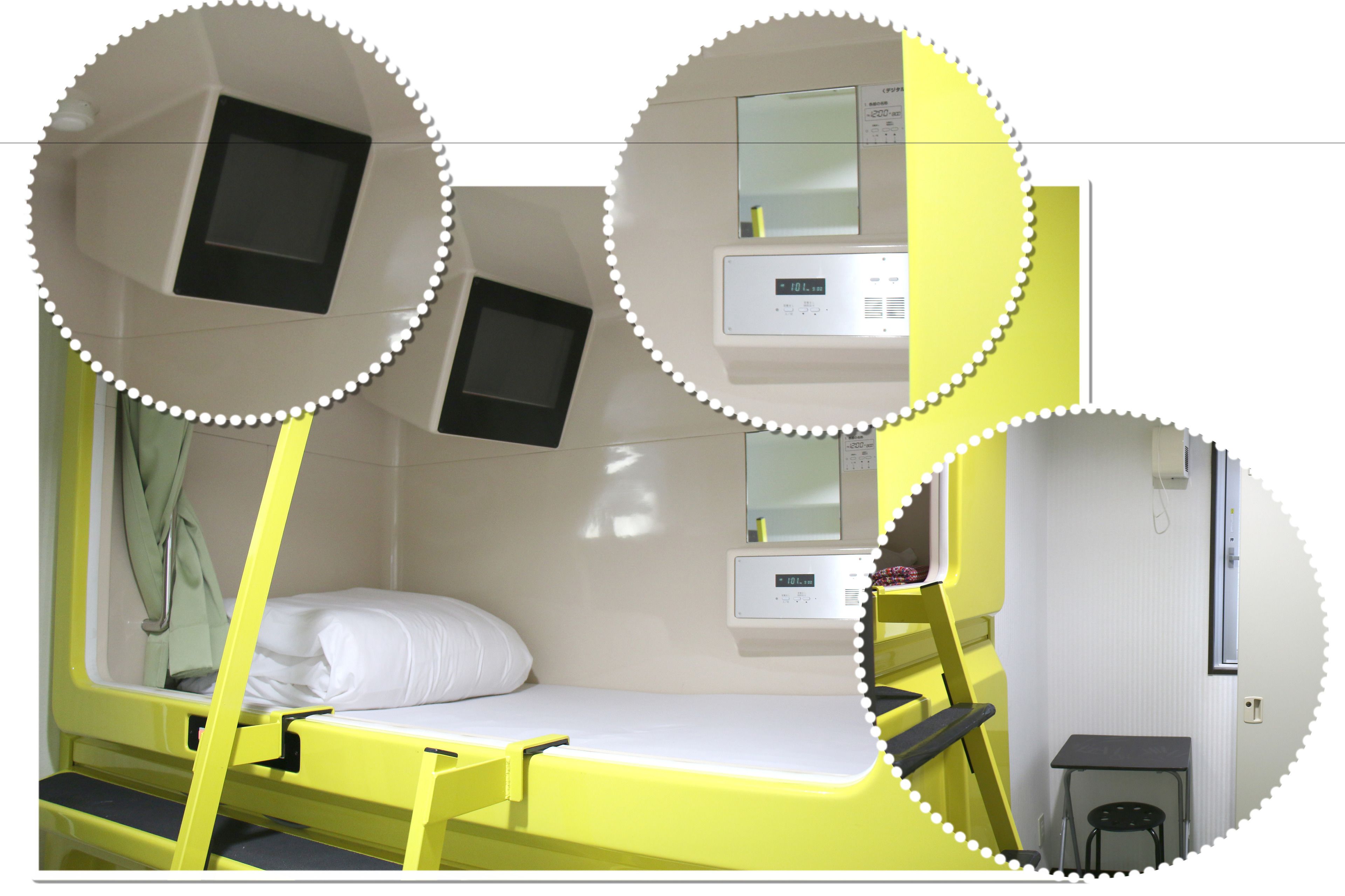 A yellow bunk bed with a small desk and a mirror.