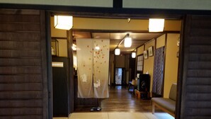A traditional Japanese room with tatami flooring, a shoji screen with autumn leaves, and a wooden desk with a chair. - Sansou Tanaka (Yufu)