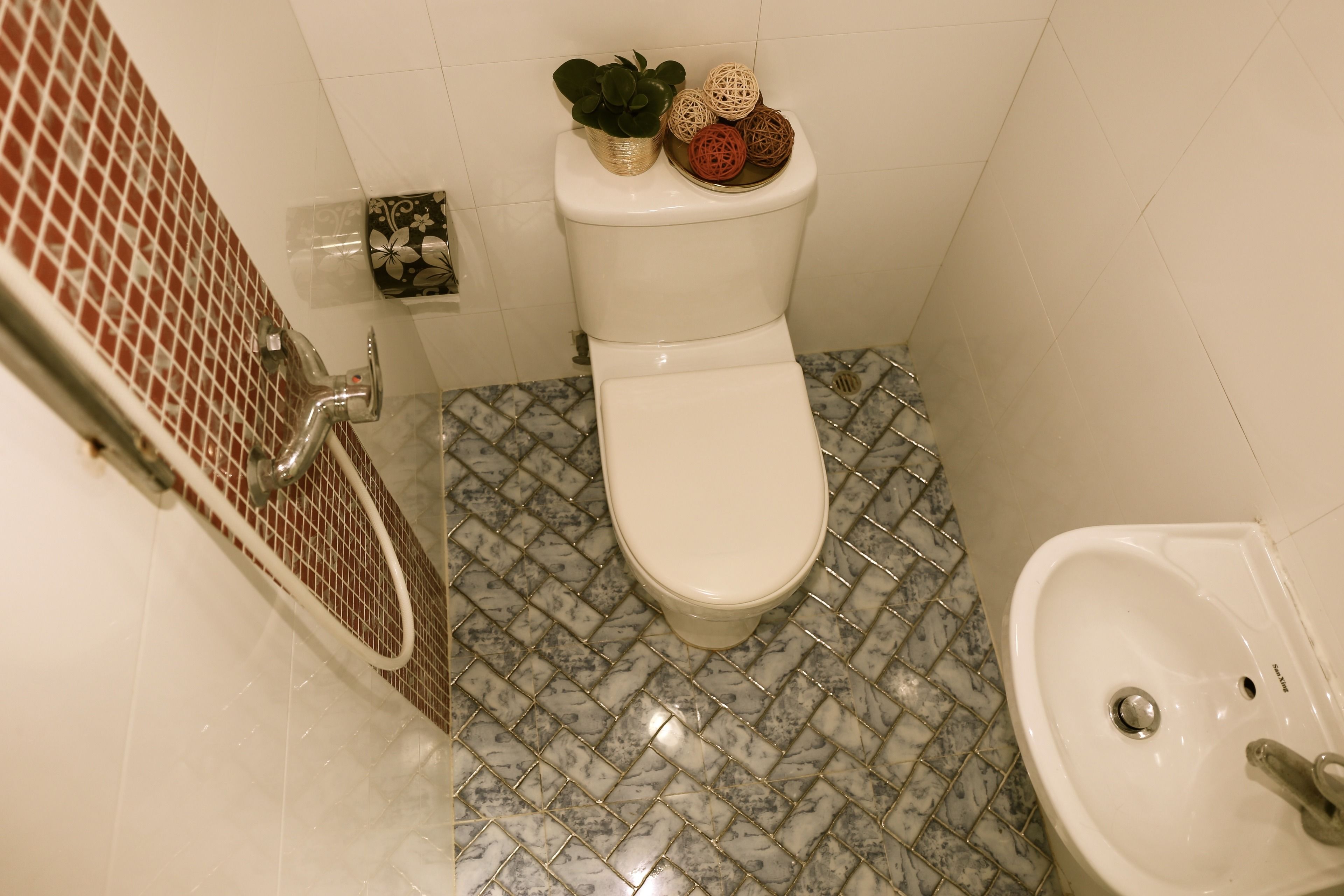 A bathroom with a toilet, sink, and shower.