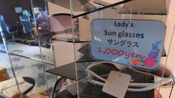 A display of sunglasses with a sign indicating a price of 1,000 yen.