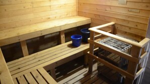 A sauna with wooden benches and a metal rack. - Paddle Wheel Inn (Oregon)