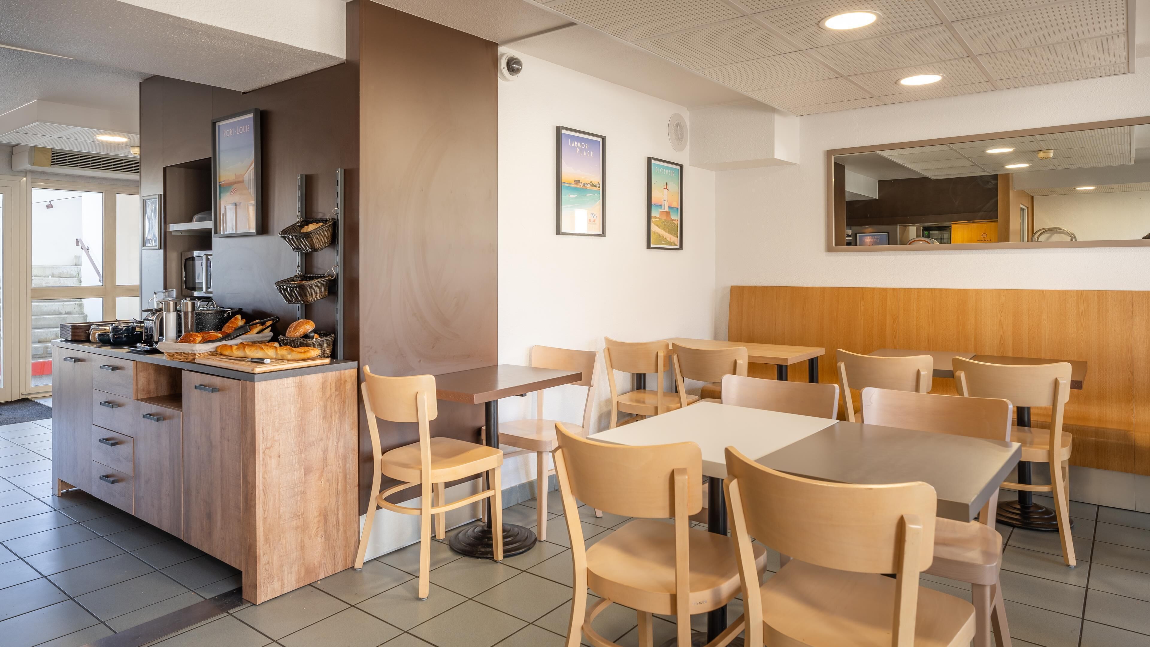 A restaurant interior with a counter, chairs, and tables.