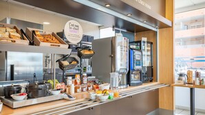 A breakfast buffet with various food items, a coffee machine, and a sign indicating a chef. - B&B HOTEL Martigues Port-de-Bouc (Port-de-Bouc)
