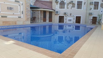 Piscine extérieure, parasols de plage, chaises longues