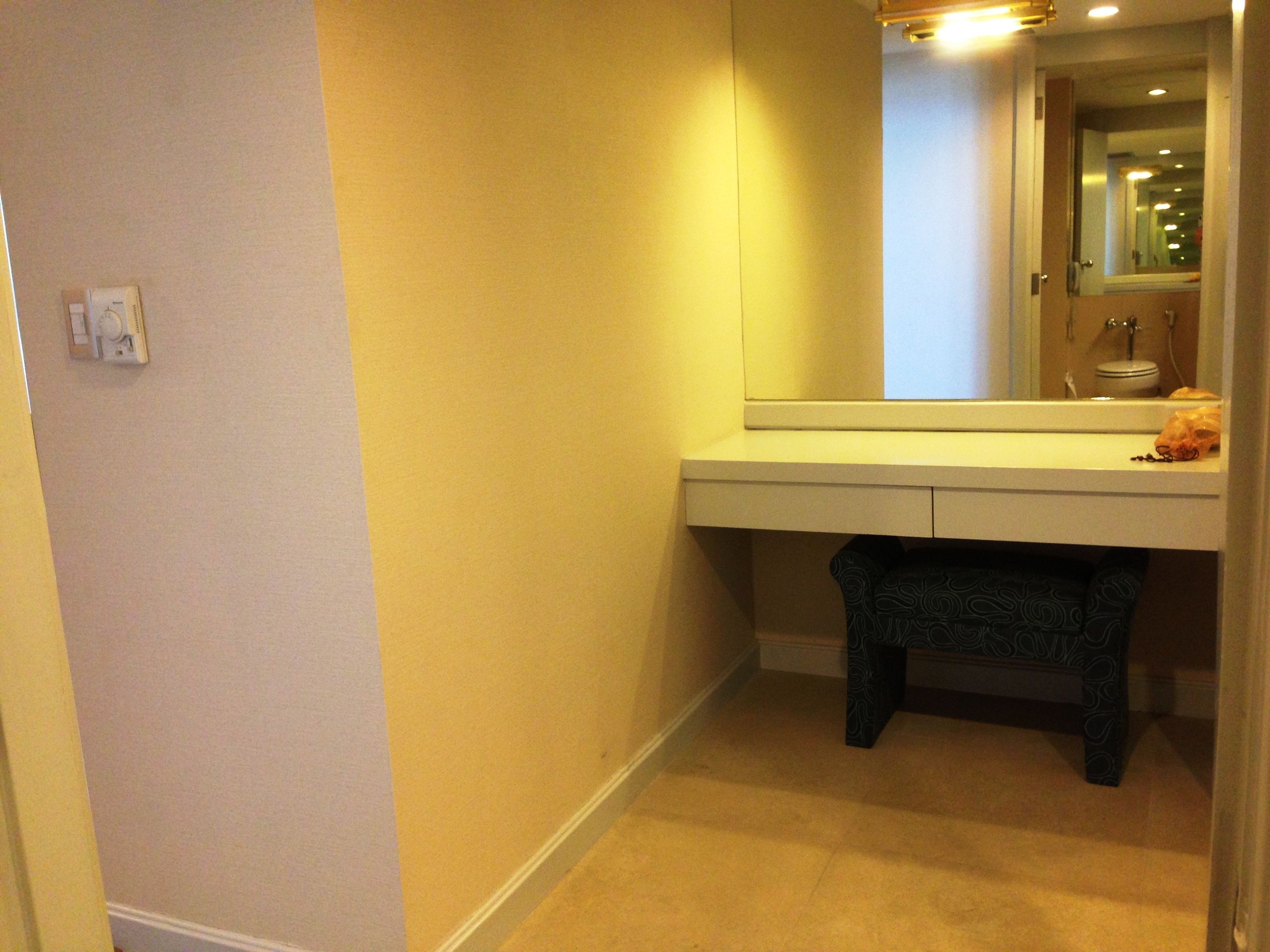 A bathroom with a sink, mirror, and toilet.