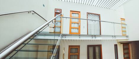 A modern building with a glass staircase leading to a second floor.