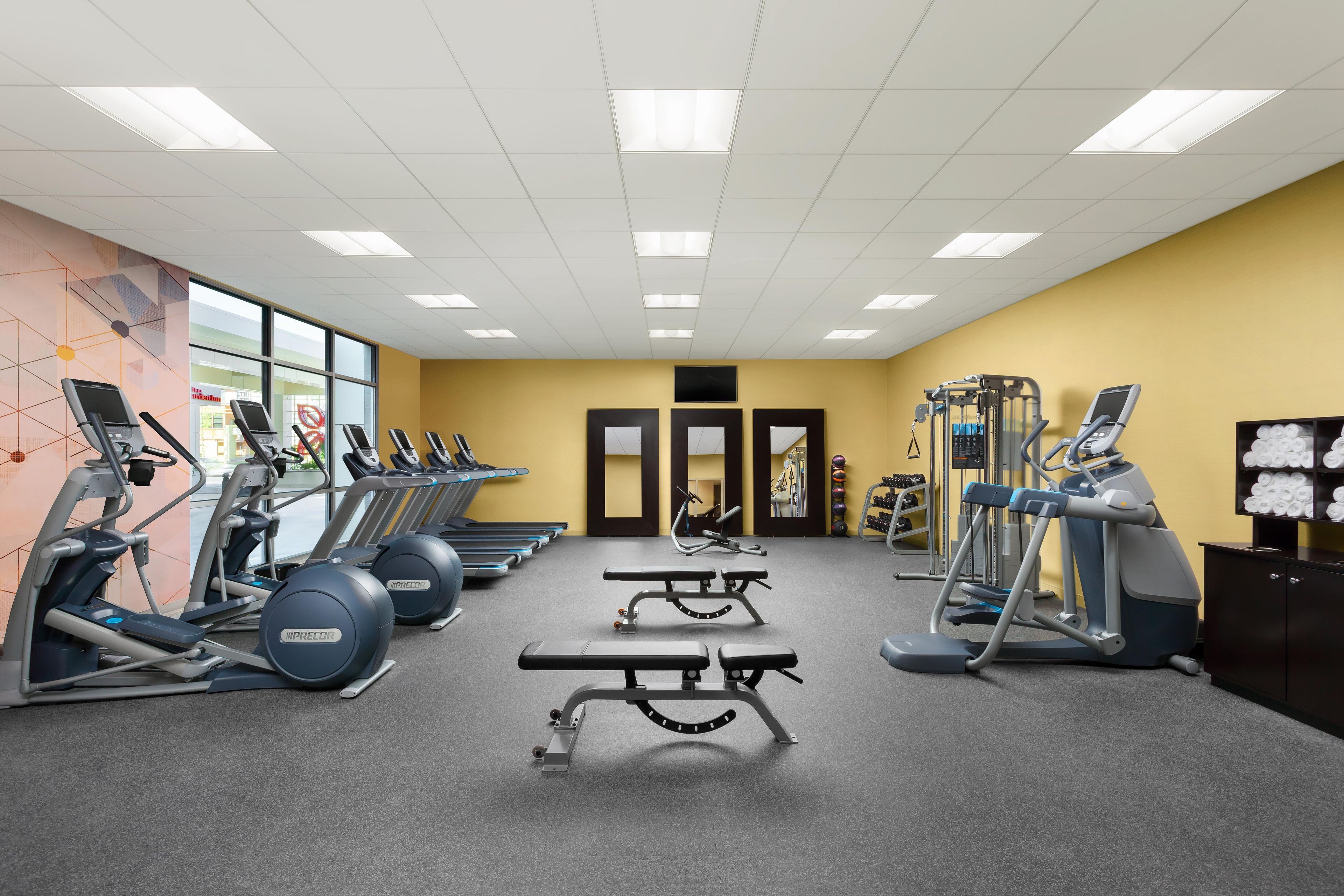 A gym with treadmills, ellipticals, and weight machines.