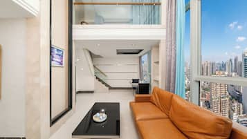 Suite Deluxe, 2 habitaciones | Zona de estar | Una televisión de pantalla plana