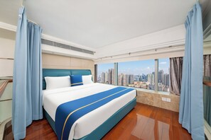 A hotel room with a large bed, a city view, and a balcony. - Louidon Mega Duplex Apartment - Beijing Rd (Guangzhou)