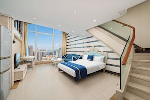 A modern hotel room with a large bed, a desk, a chair, and a view of the city. - Louidon Mega Duplex Apartment - Beijing Rd (Guangzhou)