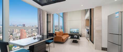 Deluxe Suite, 2 Bedrooms | Living area | Flat-screen TV