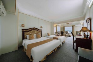 A hotel room with two beds, a desk, a chair, and a view of the sea. - Hoang Long Hotel - Hai Phong Center (Hai Phong)