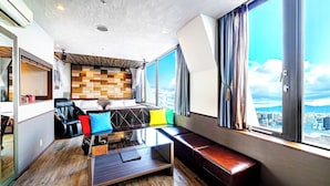 A modern hotel room with a city view, a sofa, a coffee table, and a dining area. - Anda no Mori Osaka Tennoji Tower (Osaka)