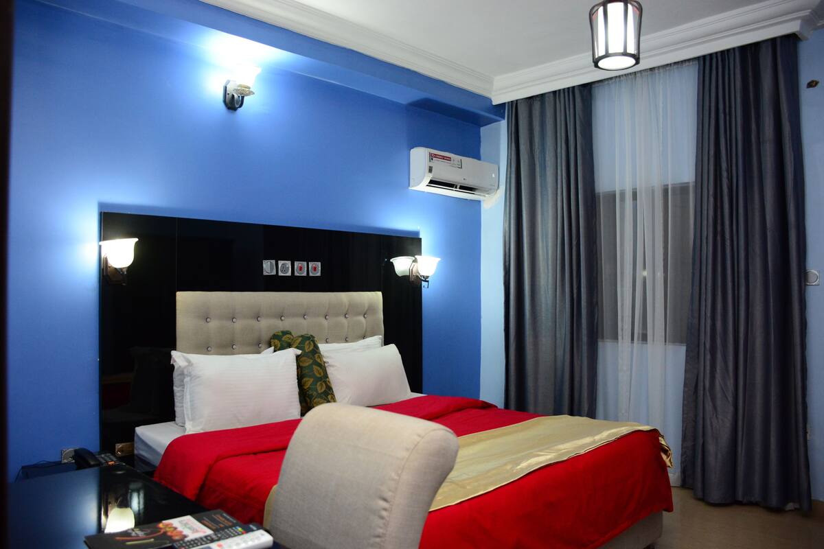 Premium bedding, desk, laptop workspace, blackout drapes