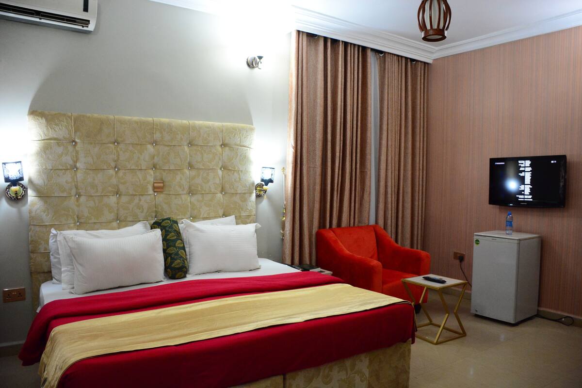 Premium bedding, desk, laptop workspace, blackout drapes