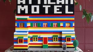 Une maquette LEGO représentant un motel, avec une enseigne indiquant « ATTICAN MOTEL » et une structure colorée.