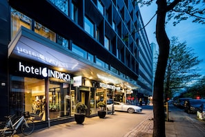 A hotel with a modern facade, large windows, and a sign for 'hotel INDIGO'. - Hotel Indigo Helsinki - Boulevard by IHG (Helsinki)
