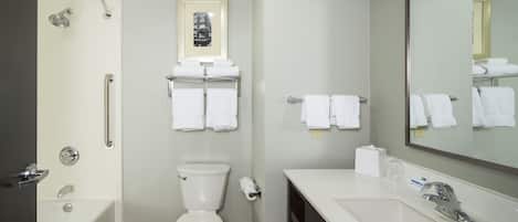 A modern bathroom with a bathtub, toilet, and sink.