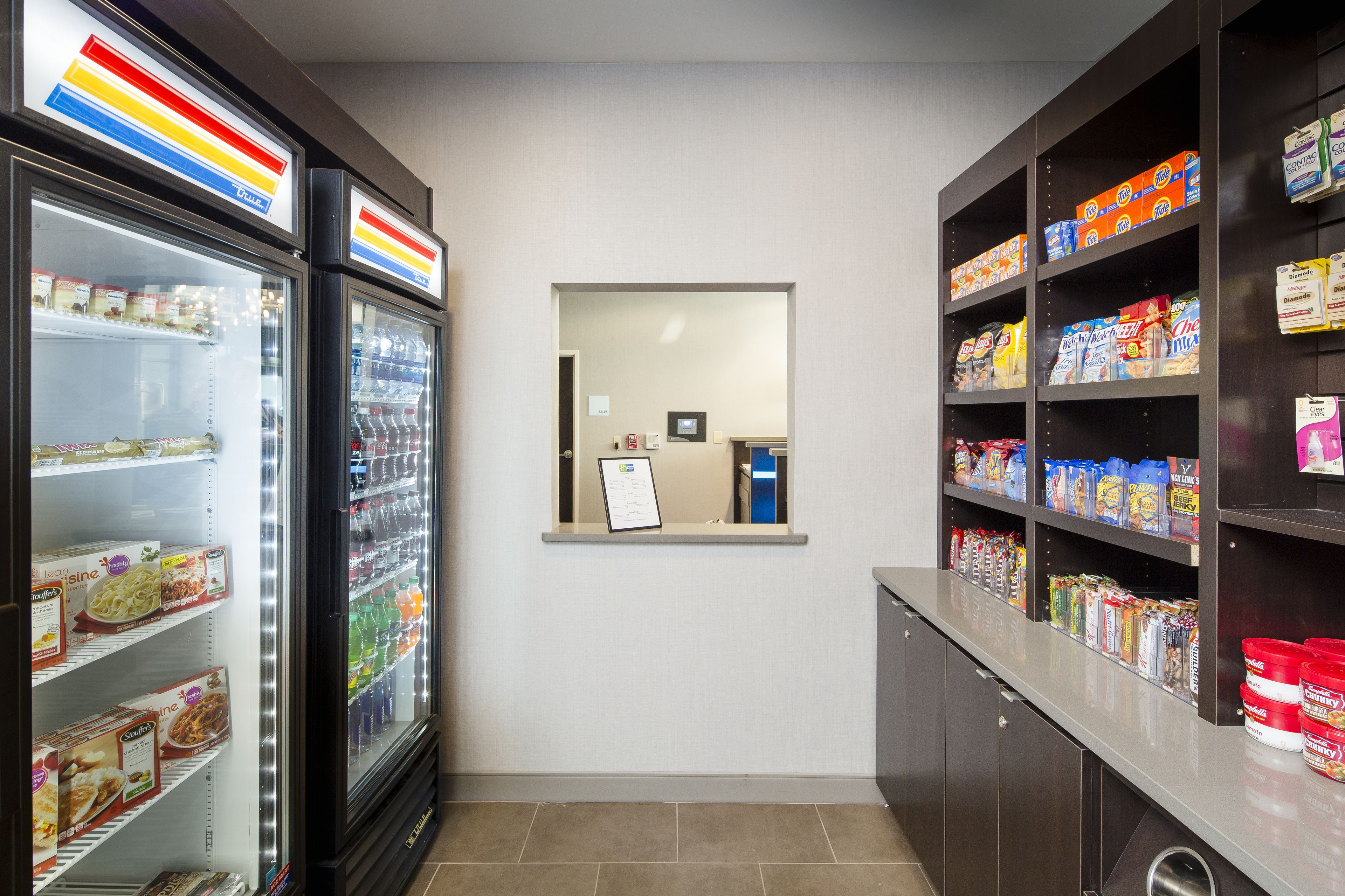 A clean, well-organized snack bar with refrigerated and shelf storage for beverages and snacks.