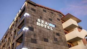 A hotel with a modern facade, featuring the name 'SEA VIEW HOTEL' prominently displayed on the building. - Sea View (Jeju City)