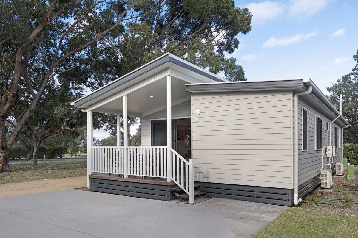 A single-story house with a covered porch and a small attached garage.