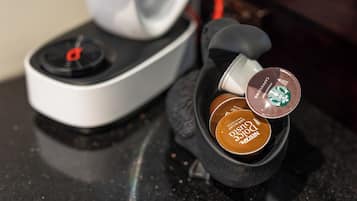 A coffee machine with two coffee pods, one labeled 'Cappuccino' and the other 'Dunkel.'