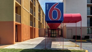 A motel with a large '6' sign, a covered walkway, and a parking lot. - Motel 6 Jackson, TN (Jackson)