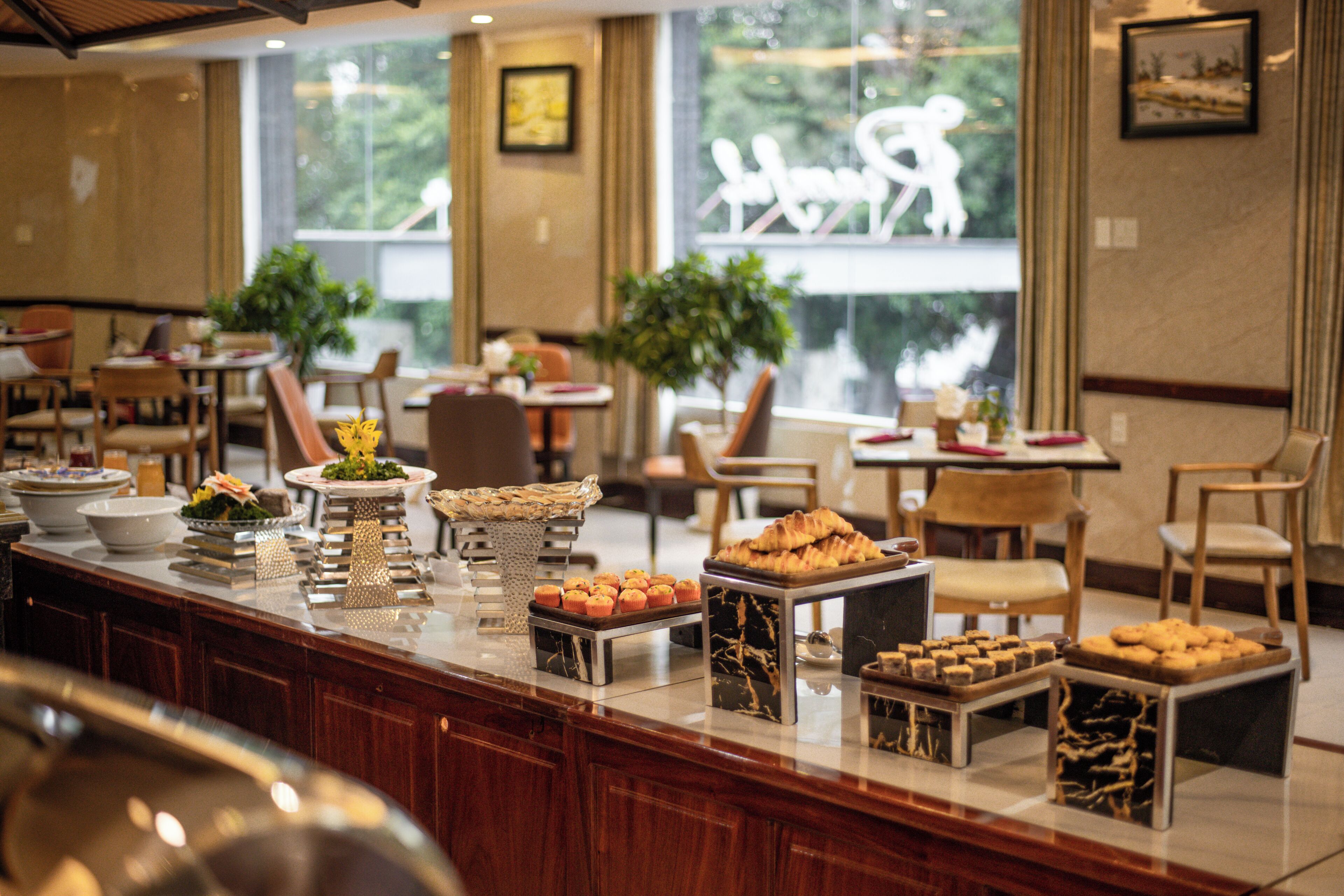 A buffet area with various food items and a seating arrangement with tables and chairs.