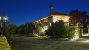 A stone house with a red-tiled roof, surrounded by trees and a gated driveway. - Villa Agape in Kala Nera Pelion (South Pelion)