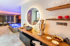A modern bathroom with a wooden vanity, a large mirror, and a heated floor.