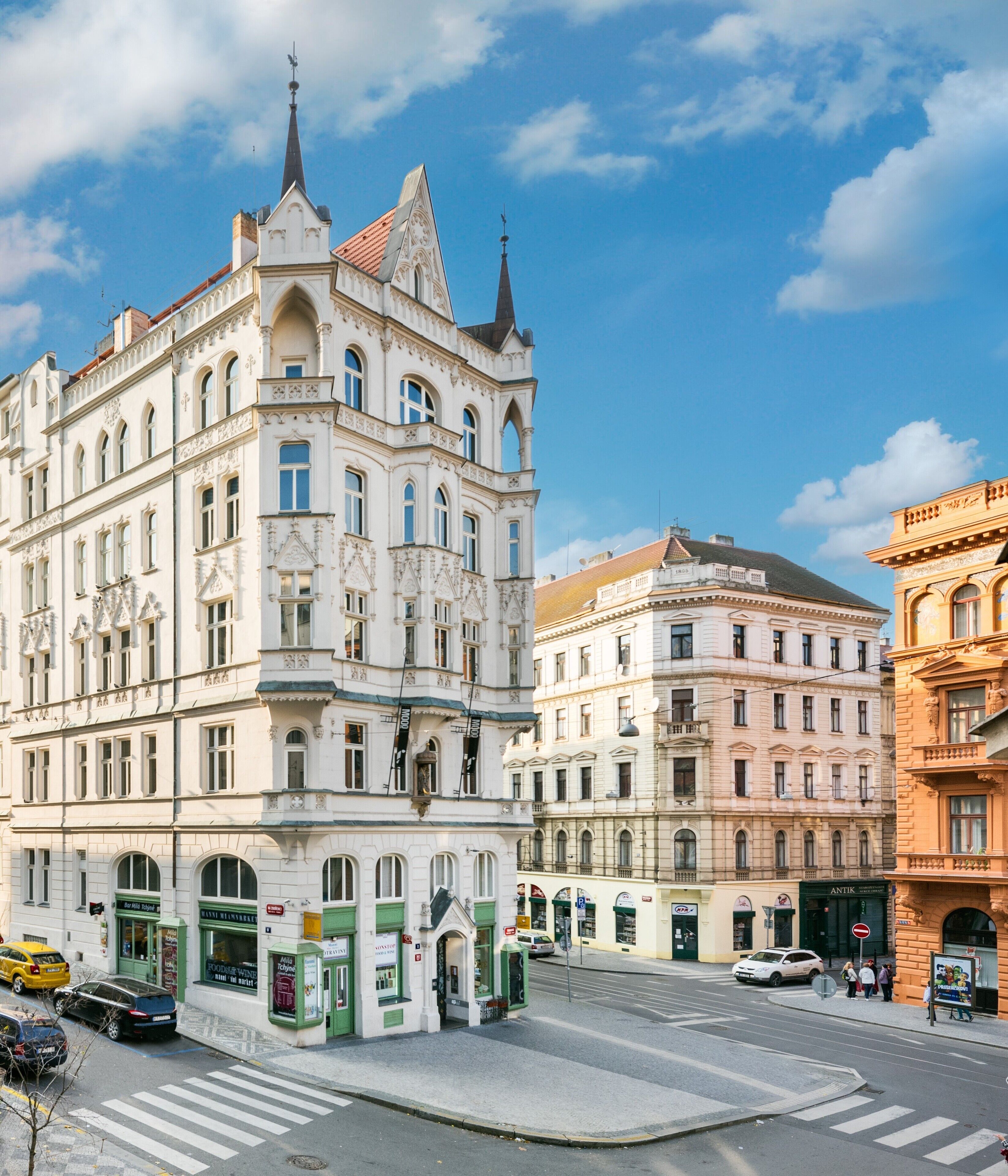 A historic building with ornate architecture, large windows, and a prominent corner tower.