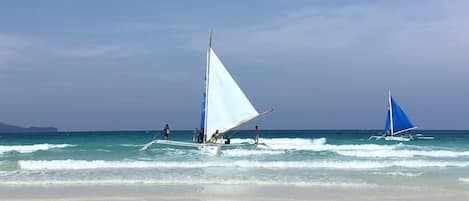 Beach nearby, white sand, beach towels