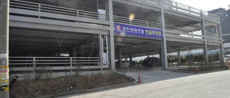 A multi-level parking structure with a blue sign indicating a parking lot.