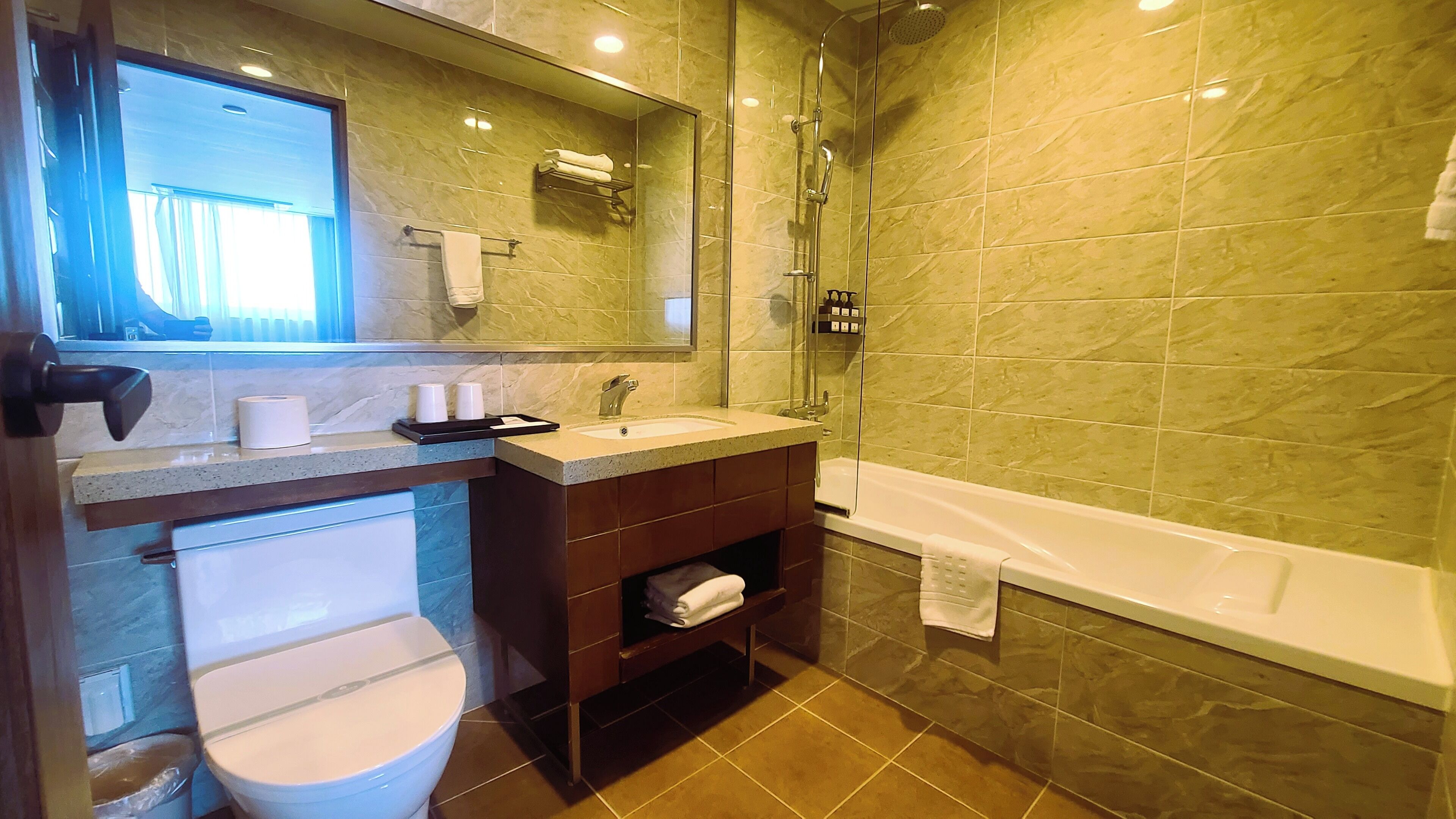 A bathroom with a toilet, sink, and shower.