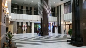 A spacious lobby with a central column, multiple floors, and a modern design.