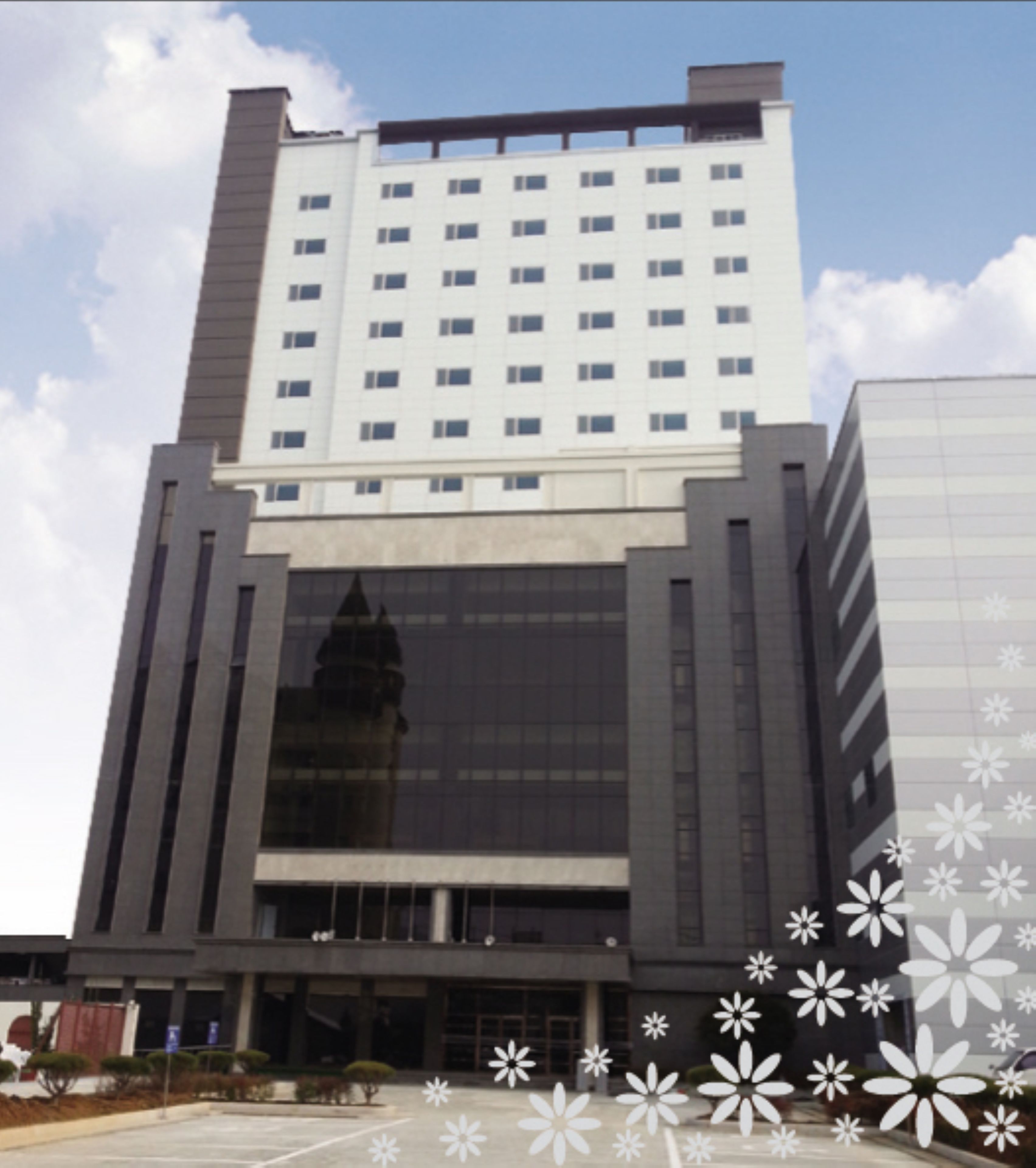 A modern building with a central glass facade and a symmetrical design.