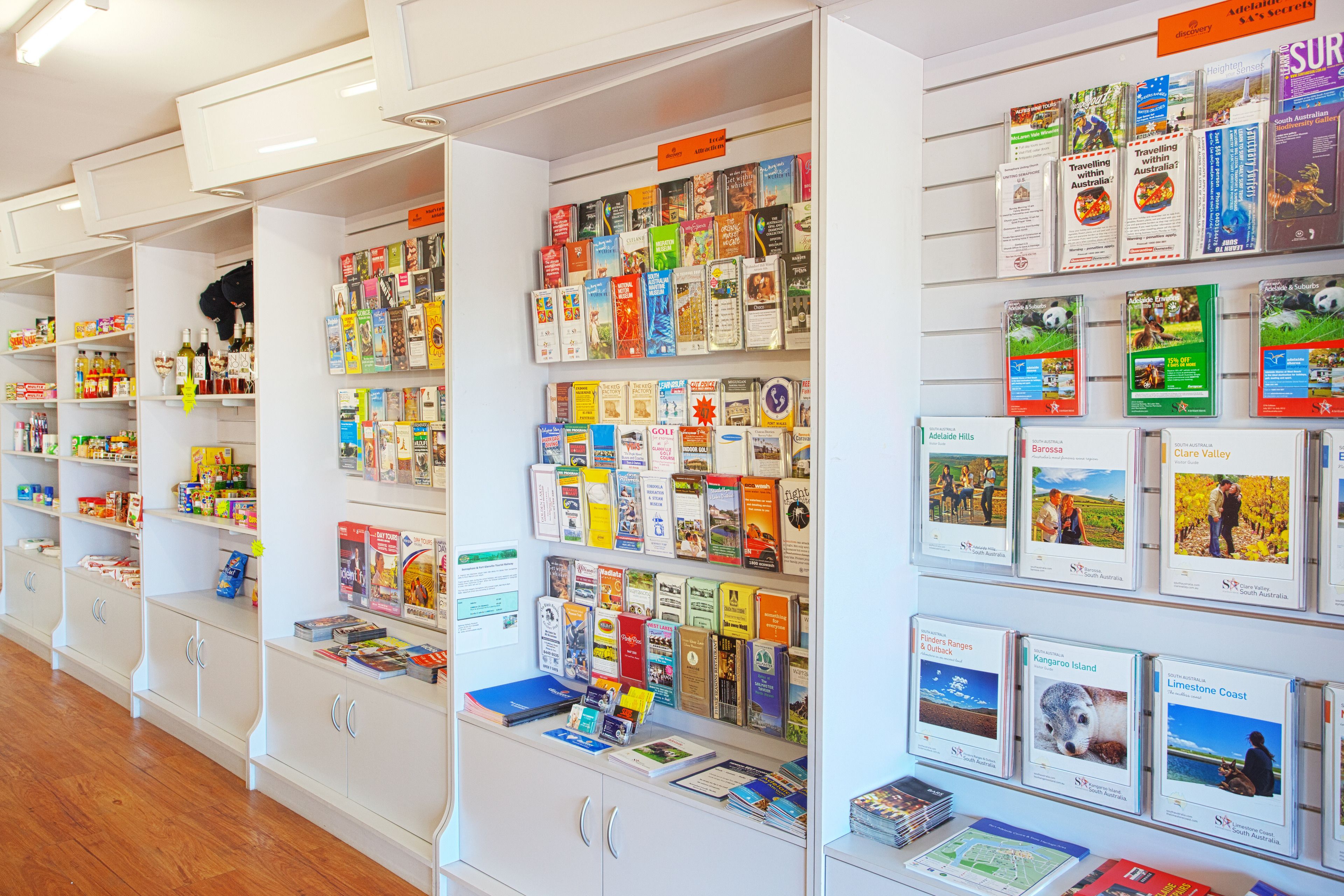 A travel information desk with brochures and maps for various destinations.