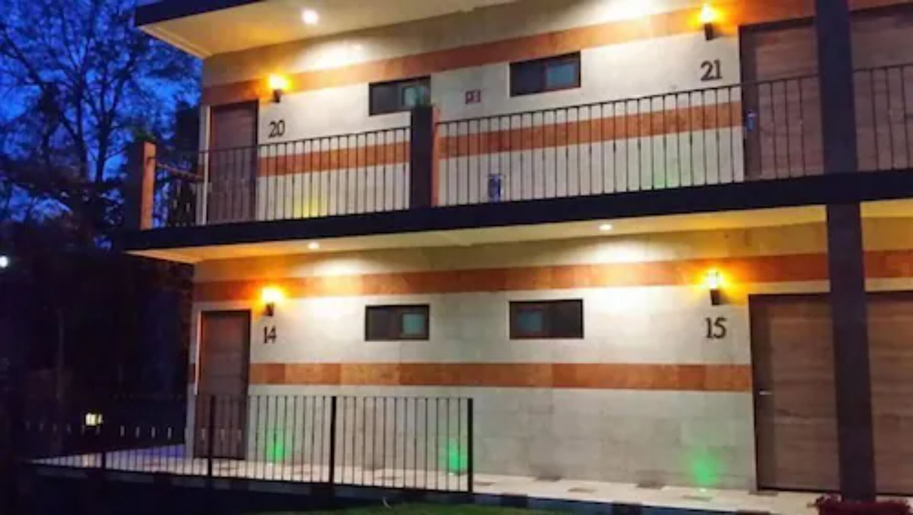 A two-story building with numbered balconies.