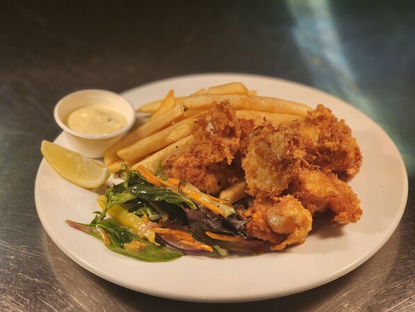A plate of fried fish, fries, salad, and a small bowl of sauce. - Central Hotel Hobart (Hobart)