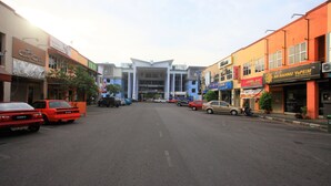 A street with parked cars and buildings with various signs. - Geopark Hotel, Kuah Langkawi (Langkawi)