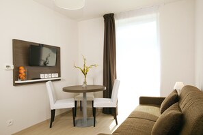 Basic Quadruple Room, 1 Bedroom | Living area | LCD TV - Séjours & Affaires Massy Atlantis (Massy)