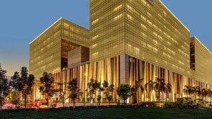 A modern hotel with a glass facade and a prominent sign reading "HYATT REGENCY". - Hyatt Regency Manila, City of Dreams (Parañaque)