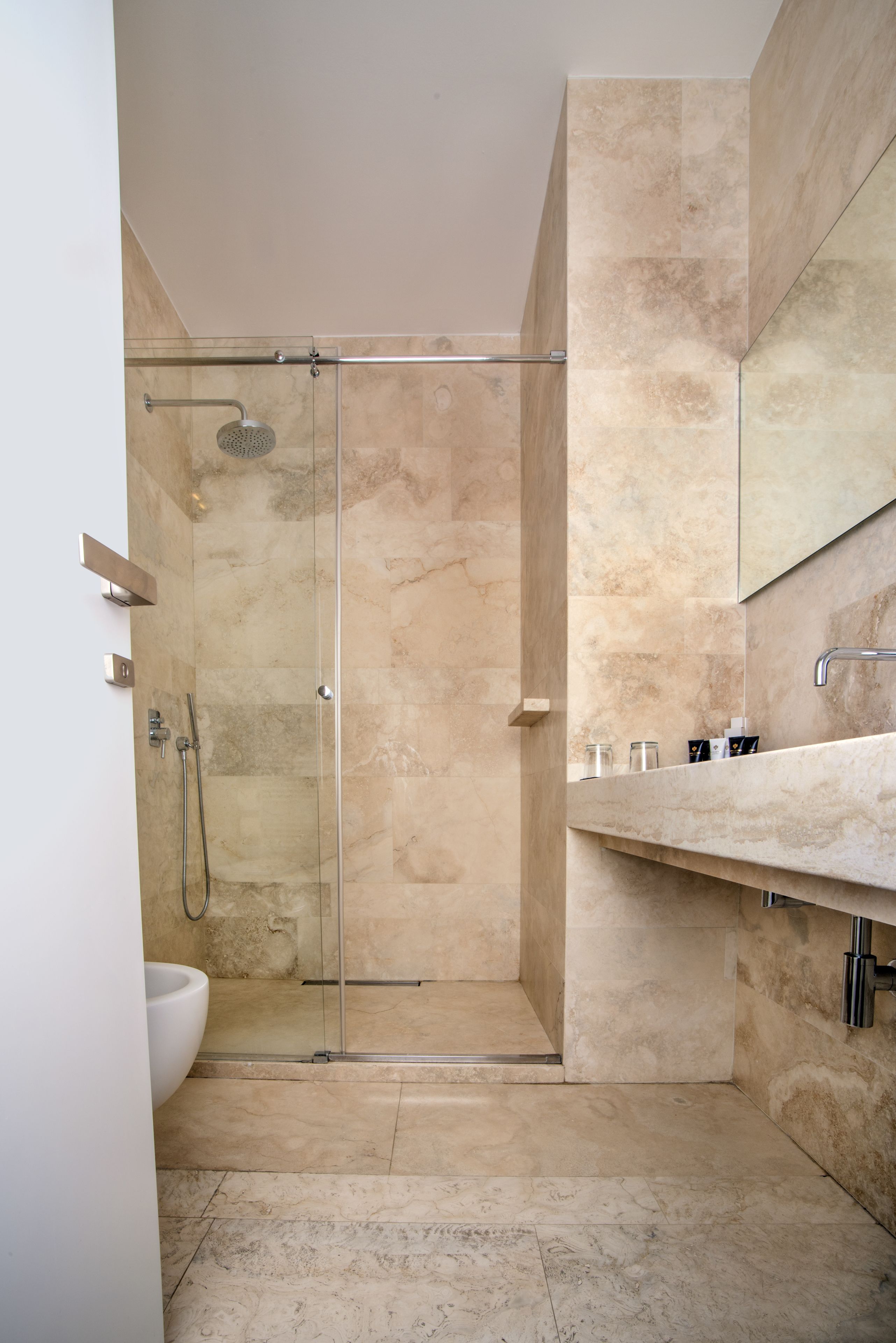 designer toiletries, hair dryer, slippers, towels