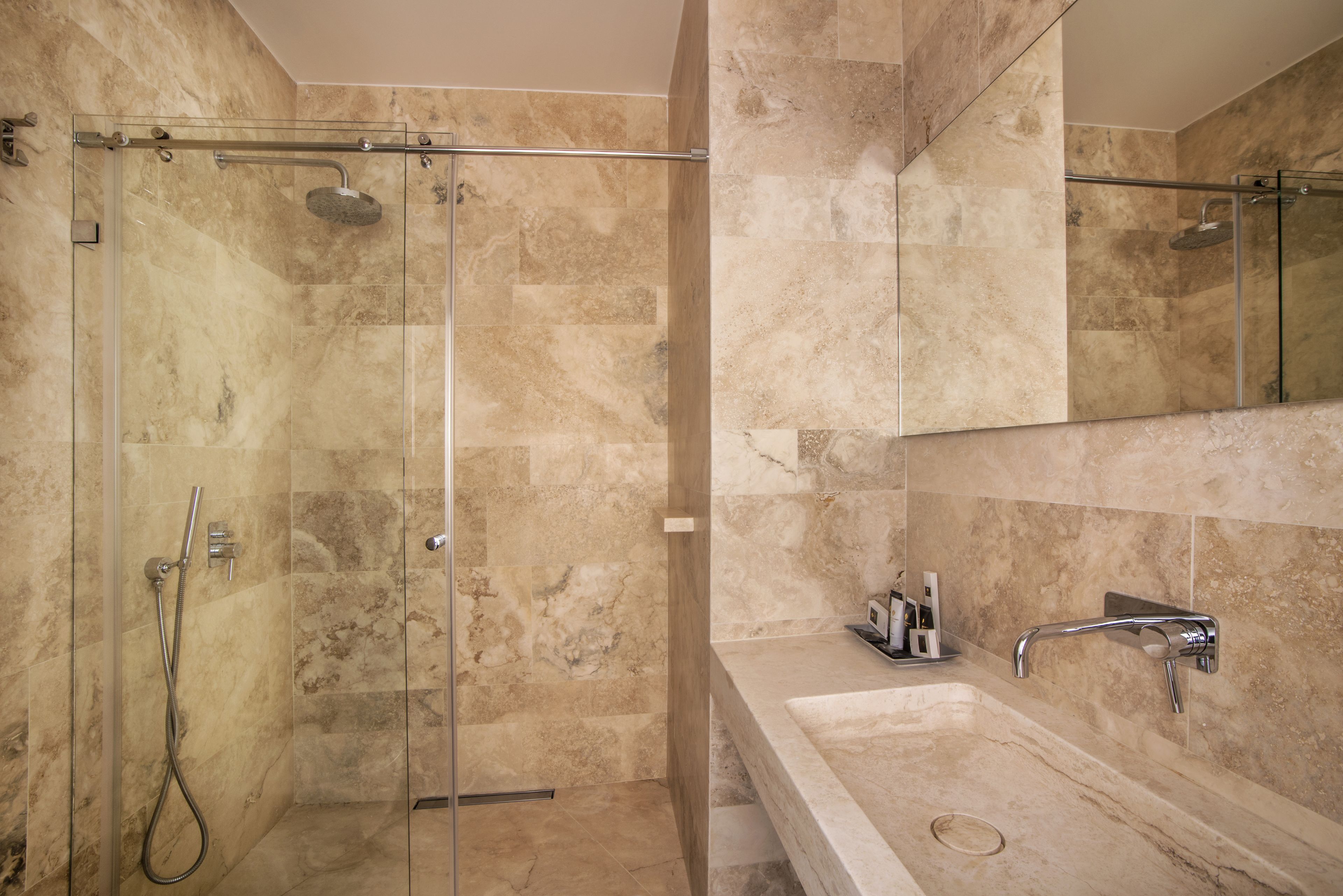 designer toiletries, hair dryer, slippers, towels