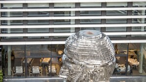 A modern building with a unique spherical glass sculpture in the courtyard. - Golden Crown (Prague)
