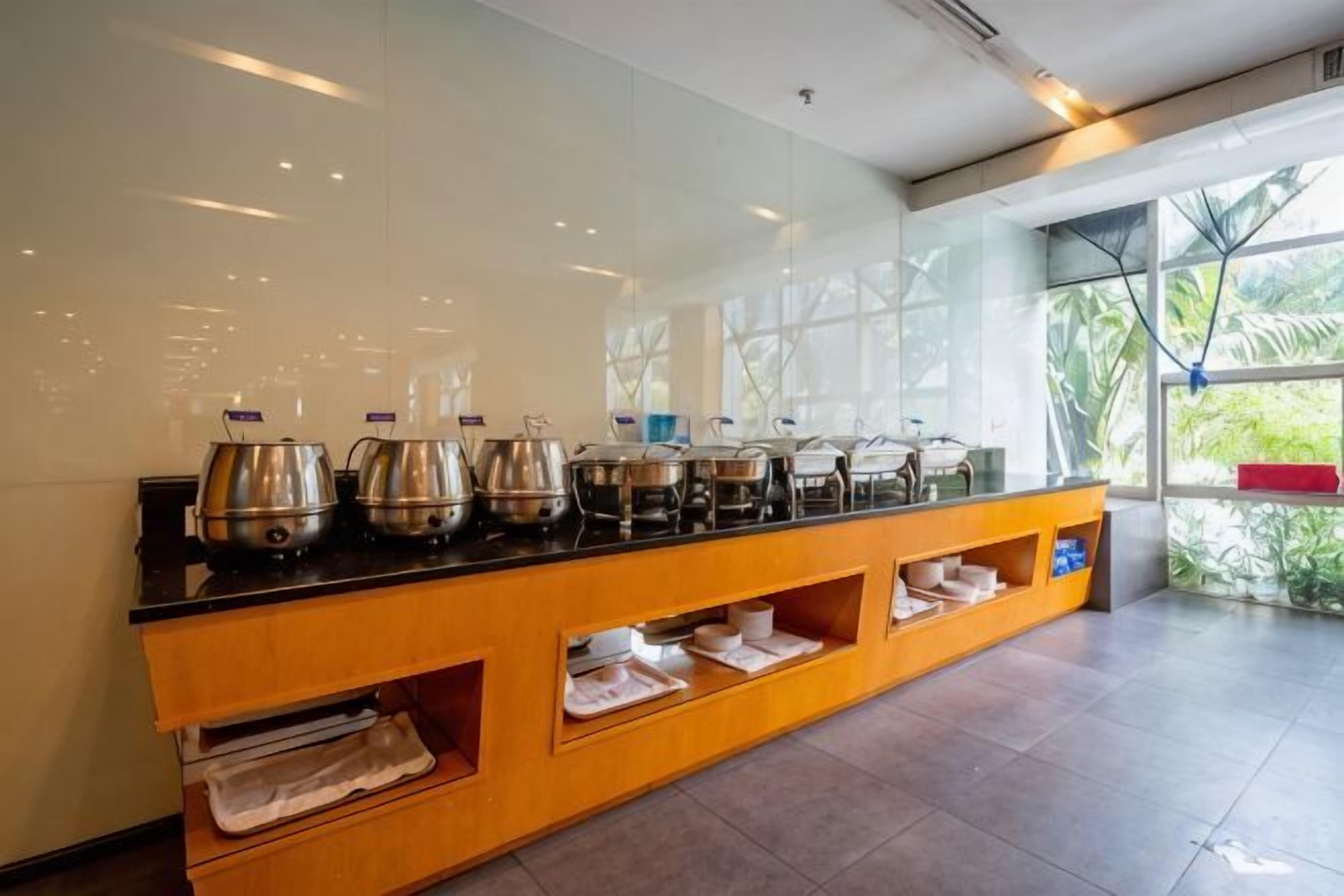 A buffet setup with multiple serving stations and a glass partition.