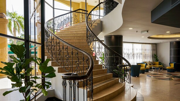 A spiral staircase with ornate metal railings, leading to an upper floor. - Shahzan Hotel Kuantan, Trademark Collection by Wyndham (Kuantan)