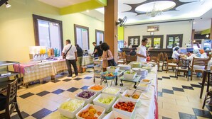 A buffet setup with various food stations and a check-in counter in a restaurant. - Phuphaya Resort Pattaya (Pattaya)